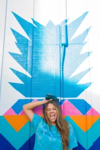 Woman standing in front of a graphite.